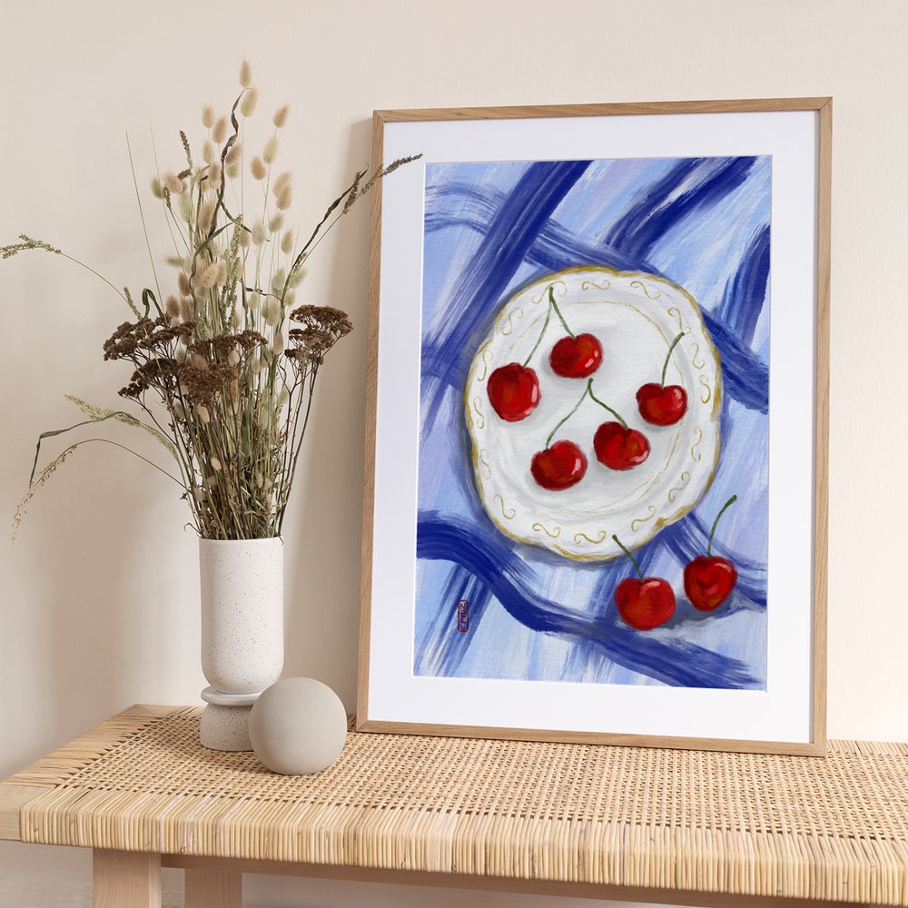 Red Cherries Blue Table - Art Print by Dirkie Nell
